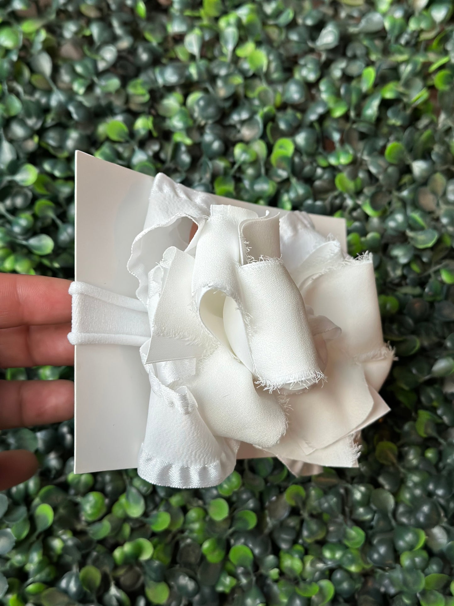 Enhance your look with a touch of playful elegance using our white Chiffon Ruffle Bow. This bow (4.5" wide) boasts layers of double ruffle ribbon and satin chiffon, making it ideal for any event. Choose between an alligator clip or nylon headband for easy styling.