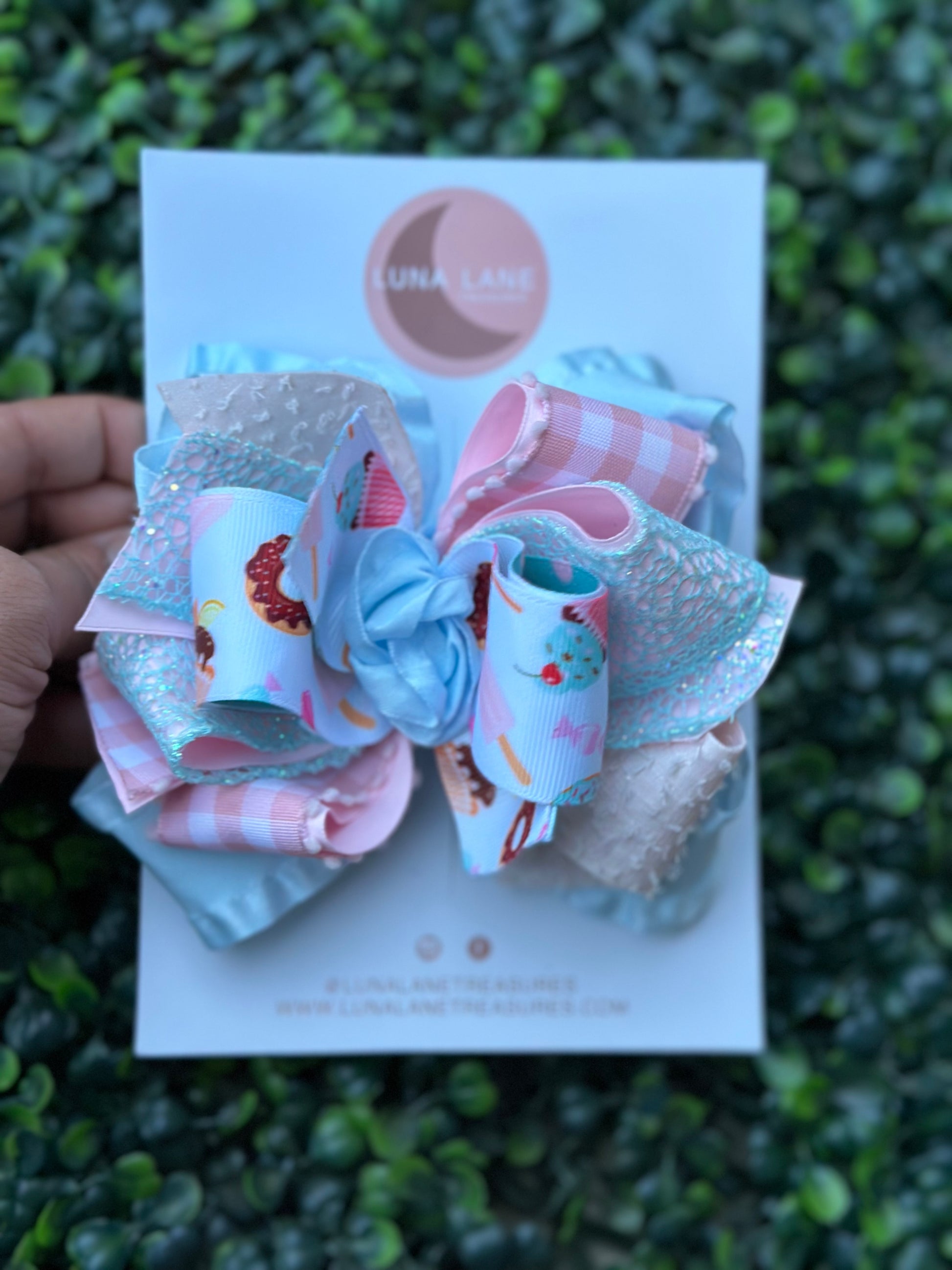 Introducing our Cupcake middle knot Ruffle Hair Bow. This ruffle ribbon hair bow is about 5 inches wide and made from high-quality grosgrain, glitter, plaid, and ruffle ribbon. Perfect for any little girl who loves big bows, attached to an alligator clip or nylon headband.