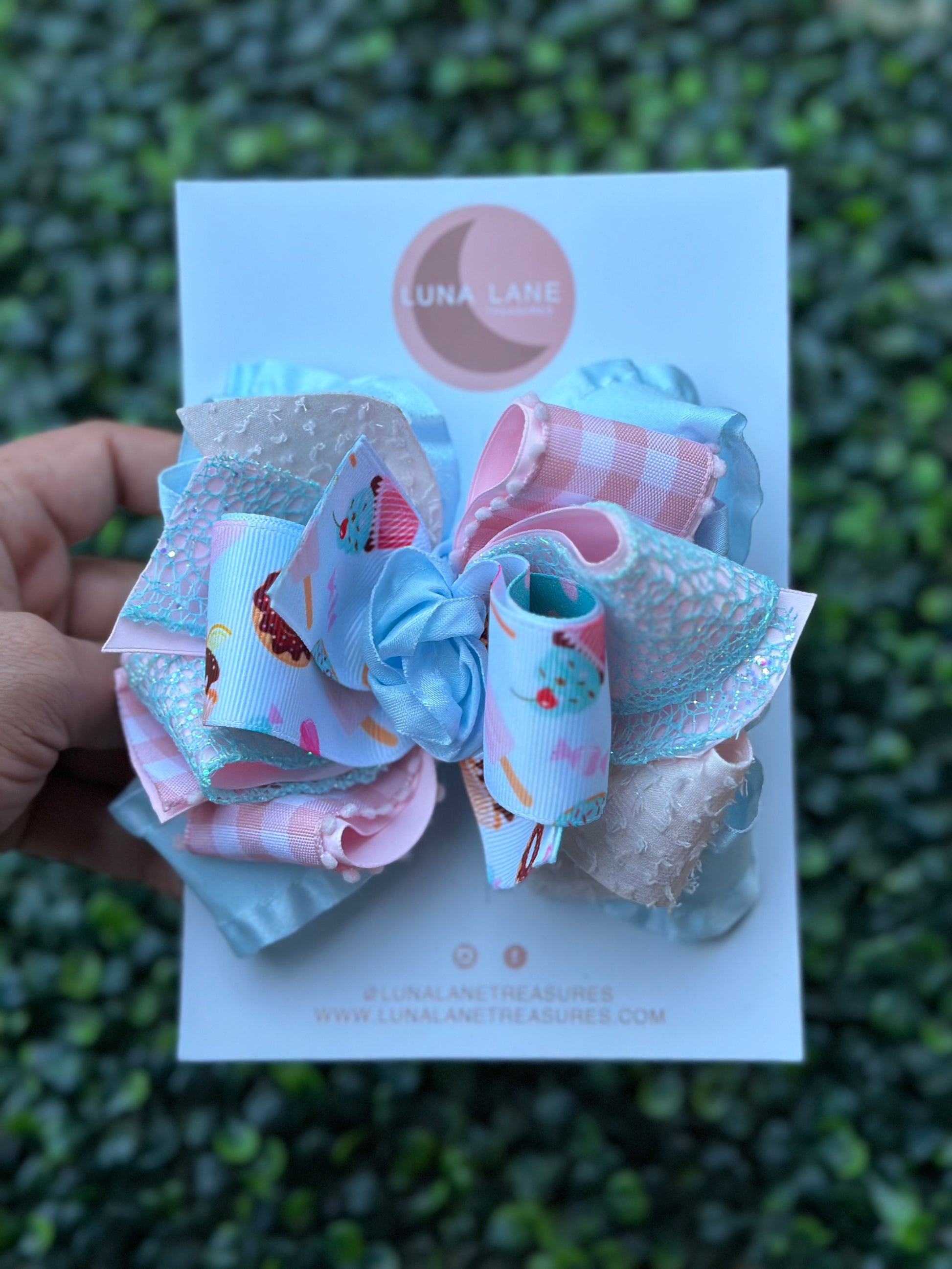 Introducing our Cupcake middle knot Ruffle Hair Bow. This ruffle ribbon hair bow is about 5 inches wide and made from high-quality grosgrain, glitter, plaid, and ruffle ribbon. Perfect for any little girl who loves big bows, attached to an alligator clip or nylon headband.