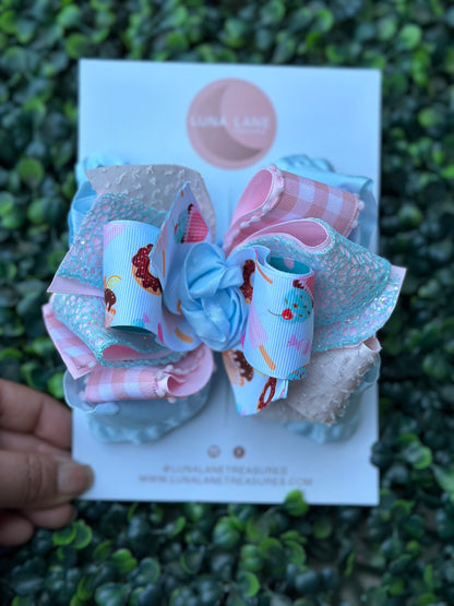 Introducing our Cupcake middle knot Ruffle Hair Bow. This ruffle ribbon hair bow is about 5 inches wide and made from high-quality grosgrain, glitter, plaid, and ruffle ribbon. Perfect for any little girl who loves big bows, attached to an alligator clip or nylon headband. 