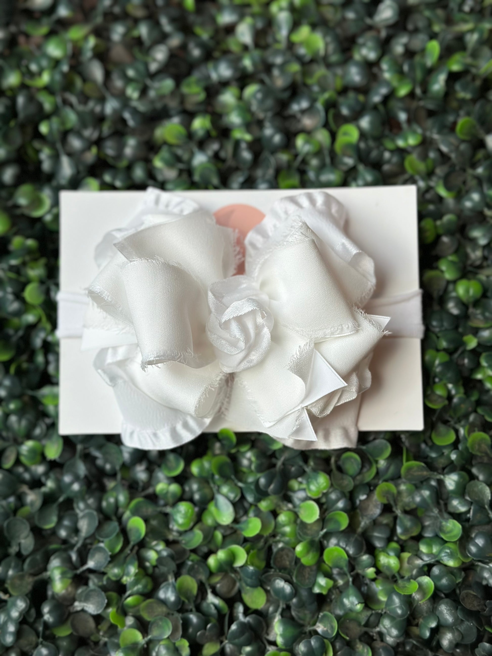    Enhance your look with a touch of playful elegance using our white Chiffon Ruffle Bow. This bow (4.5" wide) boasts layers of double ruffle ribbon and satin chiffon, making it ideal for any event. Choose between an alligator clip or nylon headband for easy styling.