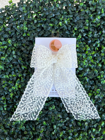 This playful Lace Vine Coquette Hair Bow is perfect for toddlers and adults alike! With a width of 5 inches and length of 8 inches, this hair bow features delicate lace trimming and a ribbon bow. Add a touch of whimsy to your hair with this versatile accessory.