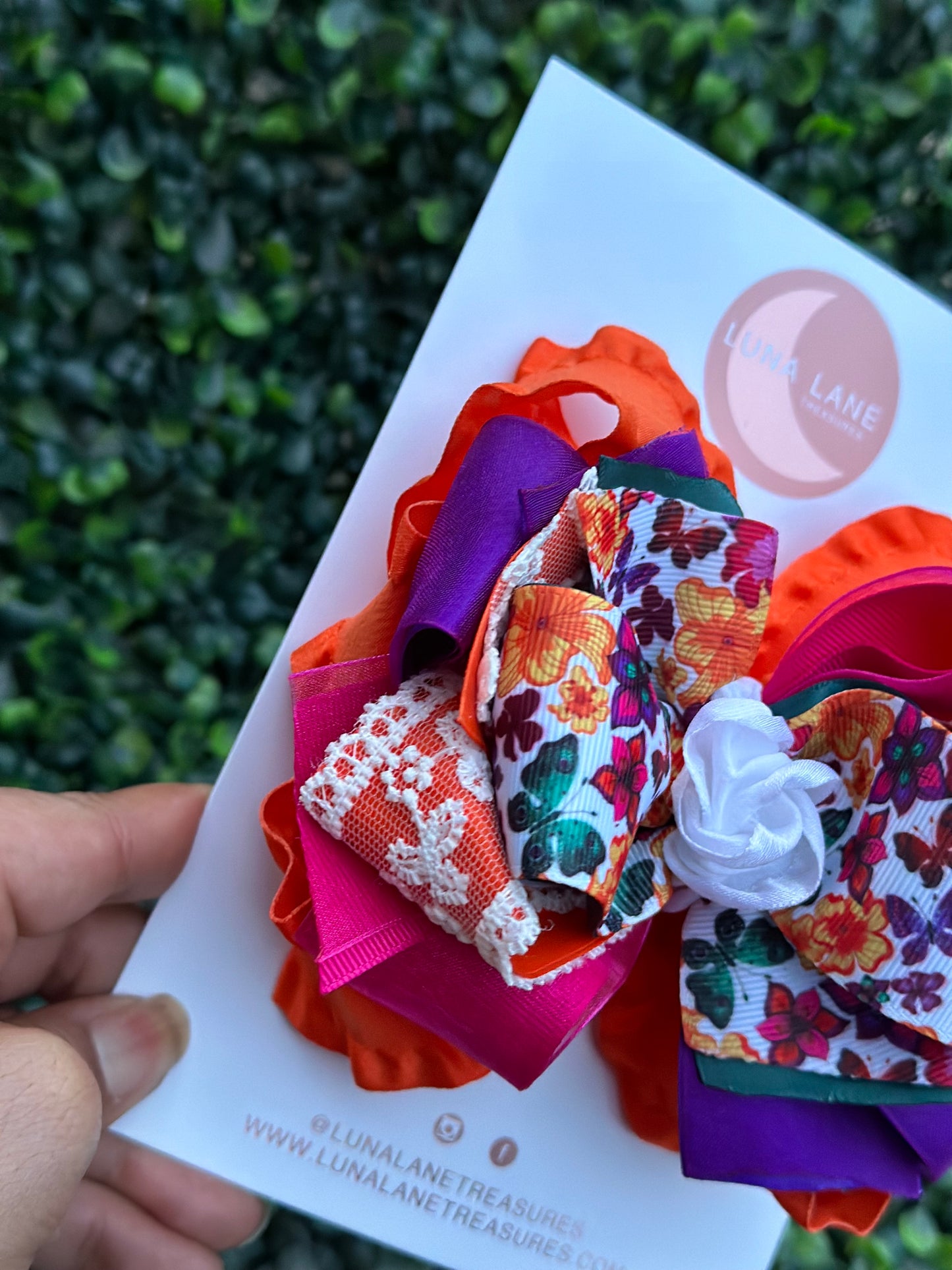 Add a touch of whimsy to any hairstyle with the Fiesta Butterflies Ruffle Hair Bow Casual. This 4-inch wide hair bow is made from a combination of ruffle, grosgrain, satin, and sheer ribbons for a truly unique look.